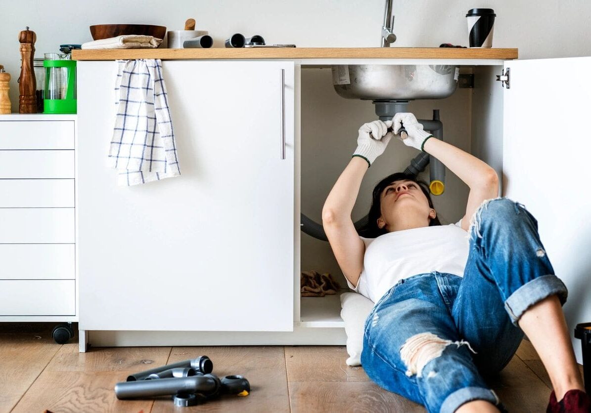 Woman fixing her sink